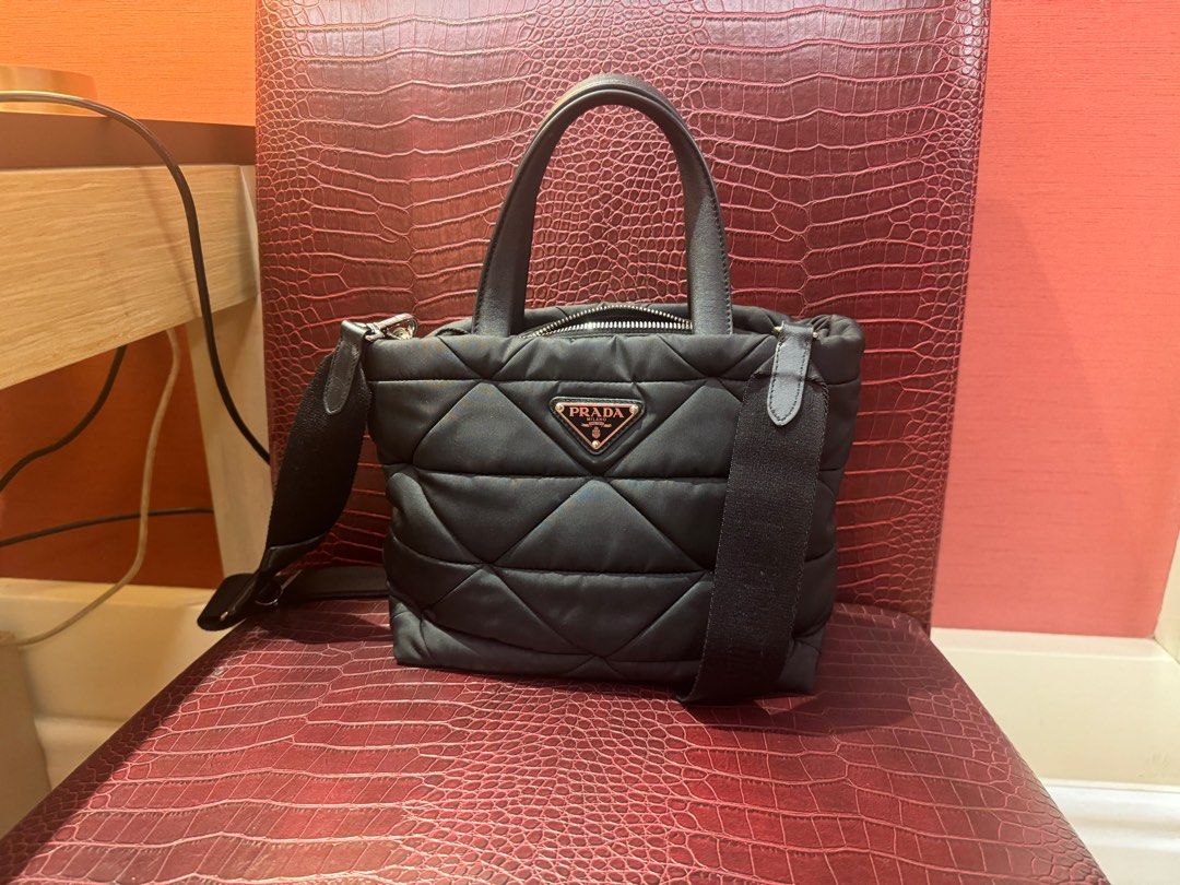 prada renylon tote bag (Category: Luxury Bags & Wallets) located in Manila. Submitted by enythingting (Listing ID 1360659589, Image 3). Description: RFs: Bag upgrade complete w/ box / dustbag /cards/ cert of authenticity Prada Re-Nylon Padded Tote Bag, featuring the brand’s signature quilted nylon material and triangular logo plaque. Prada often uses its Re-Nylon fabric, which is a sustainable, high-quality material made from recycled ocean plast