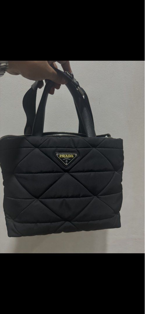 prada renylon tote bag (Category: Luxury Bags & Wallets) located in Manila. Submitted by enythingting (Listing ID 1360659589, Image 1). Description: RFs: Bag upgrade complete w/ box / dustbag /cards/ cert of authenticity Prada Re-Nylon Padded Tote Bag, featuring the brand’s signature quilted nylon material and triangular logo plaque. Prada often uses its Re-Nylon fabric, which is a sustainable, high-quality material made from recycled ocean plast
