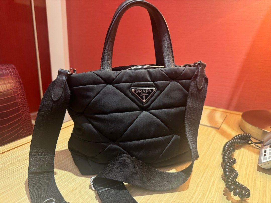 prada renylon tote bag (Category: Luxury Bags & Wallets) located in Manila. Submitted by enythingting (Listing ID 1360659589, Image 2). Description: RFs: Bag upgrade complete w/ box / dustbag /cards/ cert of authenticity Prada Re-Nylon Padded Tote Bag, featuring the brand’s signature quilted nylon material and triangular logo plaque. Prada often uses its Re-Nylon fabric, which is a sustainable, high-quality material made from recycled ocean plast
