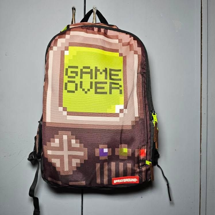 SPRAYGROUND THE GAME OVER (Category: Backpacks) located in Manila. Submitted by rewearables.mnl (Listing ID 1360628865, Image 2). Description: FOR SALE : SPRAYGROUND THE GAME OVER BAGPACK CONDITION :10/10 COLOR RATE : 8/10 ISSUE : LEATHER BRANDING IS CHIPPING OFF BUT THE OVERALL BAG COMPOSITION IS GOOD ASKING PRICE 1800.
