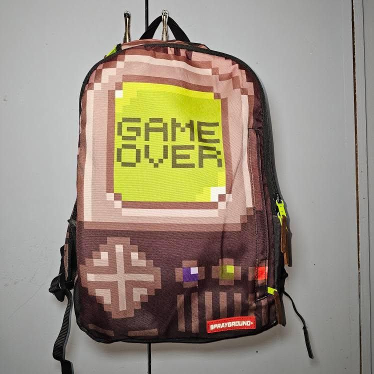 SPRAYGROUND THE GAME OVER (Category: Backpacks) located in Manila. Submitted by rewearables.mnl (Listing ID 1360628865, Image 1). Description: FOR SALE : SPRAYGROUND THE GAME OVER BAGPACK CONDITION :10/10 COLOR RATE : 8/10 ISSUE : LEATHER BRANDING IS CHIPPING OFF BUT THE OVERALL BAG COMPOSITION IS GOOD ASKING PRICE 1800.