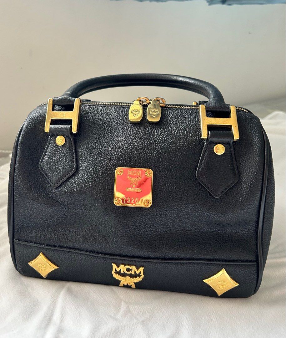 MCM BOSTON BAG - Preloved (Category: Luxury Bags & Wallets) located in Lipa City. Submitted by bituinpreloved (Listing ID 1360760985, Image 1). Description: PRELOVED MCM Boston Bag 22cm - Preloved online at £570++ or P40K++ - Cute size. Can fit big phones and wallet of course. - Excellent -Mint Condition (Still very nice and still rankA condition (Color still nice and even. White parts just reflection only . Hardware still very goldish..