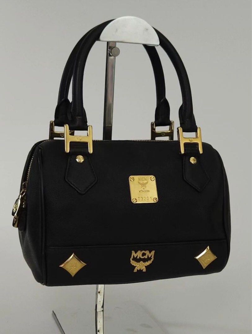 MCM BOSTON BAG - Preloved (Category: Luxury Bags & Wallets) located in Lipa City. Submitted by bituinpreloved (Listing ID 1360760985, Image 2). Description: PRELOVED MCM Boston Bag 22cm - Preloved online at £570++ or P40K++ - Cute size. Can fit big phones and wallet of course. - Excellent -Mint Condition (Still very nice and still rankA condition (Color still nice and even. White parts just reflection only . Hardware still very goldish..