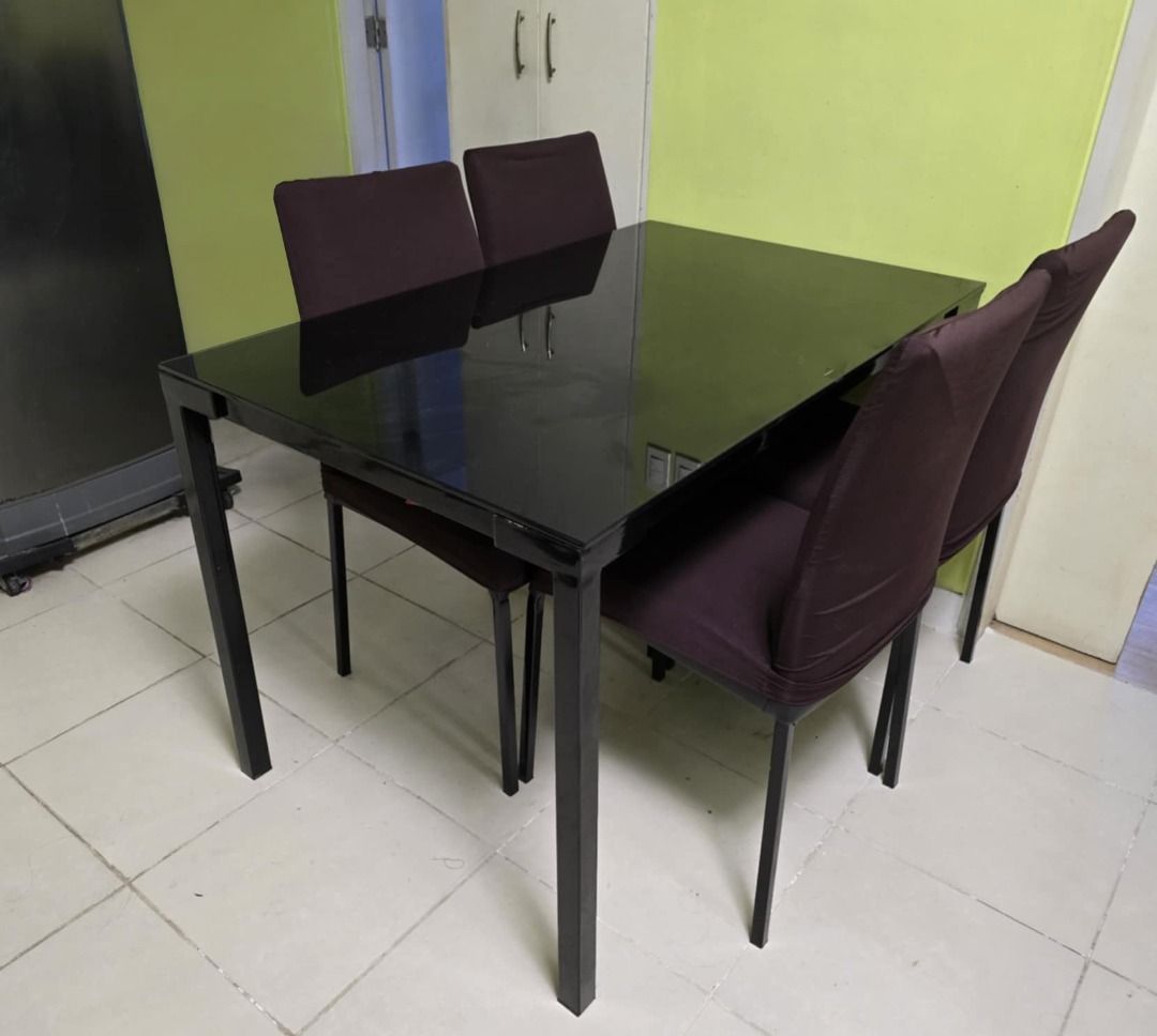 Black Tempered Glass Dining Table Set (4-Seater) (Category: Tables & Sets) located in Bacoor. Submitted by arvicius (Listing ID 1360945024, Image 2). Description: RFS: We're renovating po so, we're trying to sell our furniture Includes: 1 tempered glass table + 4 cushioned chairs Table Size: Spacious enough for 4 people, with a sturdy black metal frame Chairs: Upholstered in black fabric with comfortable padding Condition: Used, well-maintained, 