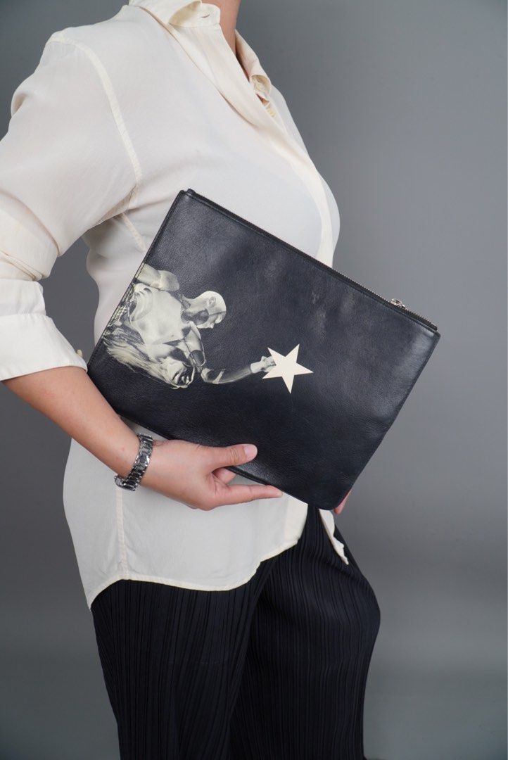 GIVENCHY (Category: Luxury Bags & Wallets) located in Manila. Submitted by zeuslikenenet (Listing ID 1356066946, Image 1). Description: Printed back and front design, givenchy under zip. Width: 11.5” Length:9” Issue: Inside powderized leather.