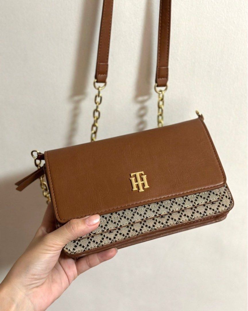 Tommy Hilfiger tan/brown chain sling bag (Category: Luxury Bags & Wallets) located in Makati City. Submitted by popmart (Listing ID 1356090176, Image 1). Description: Orig from US Unused, just stored With lots of compartments (check photos).