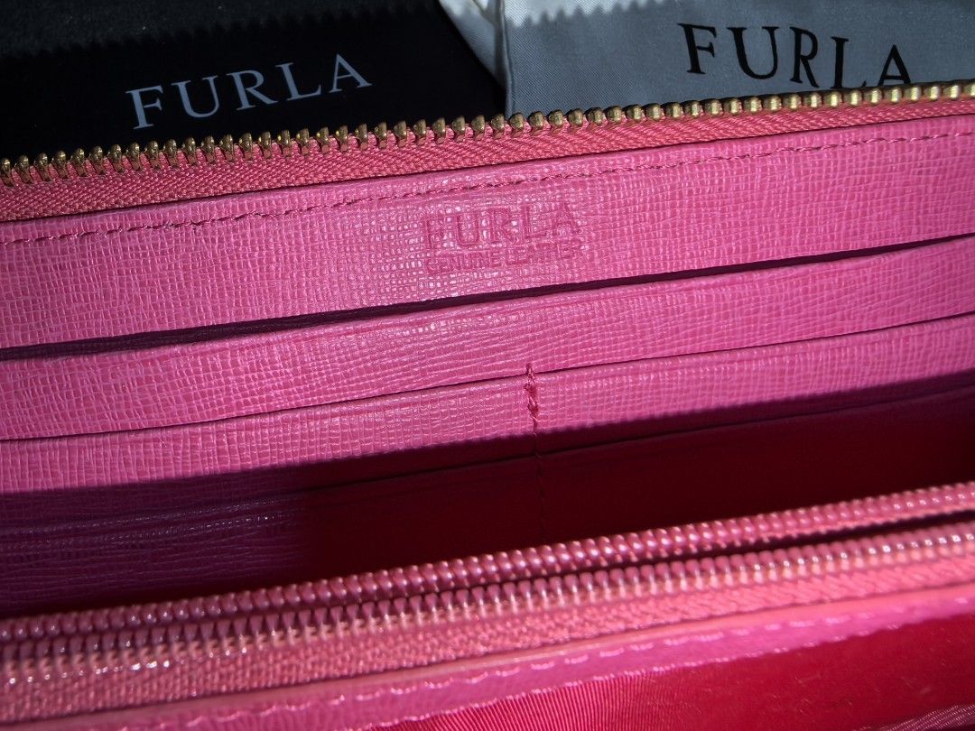 AUTHENTIC Furla Leather L-zip Long Wallet (Category: Luxury Bags & Wallets) located in Quezon City. Submitted by teppidoodles (Listing ID 1361089432, Image 2). Description: AUTHENTIC Furla Leather L-zip Long Wallet Decluttering. Rarely used. With original box. With original dust bag with little stain. No other inclusions. Personal use. No peeling. Rubs on edges. Slight discoloration of hardware. Coin stain in the coins compartment. Normal signs o