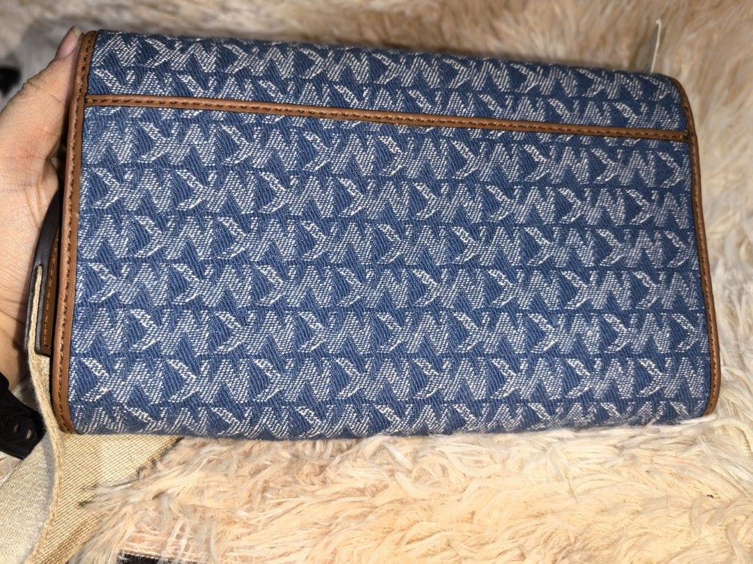 AUTHENTIC Michael Kors Denim Wallet on Chain (Category: Luxury Bags & Wallets) located in Quezon City. Submitted by teppidoodles (Listing ID 1361094847, Image 2). Description: AUTHENTIC Michael Kors Denim Wallet on Chain Decluttering. Unused and just stored. Still with Tag. Wide removable strap which can be repurpose for other MK bags. With original booklet. No other inclusions. No peeling. Not noticeable spots on the hardware due to storage. Nor