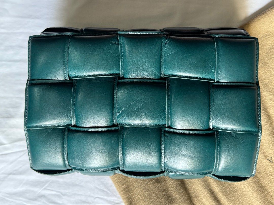 AUTHENTIC Bottega Veneta Padded Cassette (Category: Luxury Bags & Wallets) located in Tarlac. Submitted by cheapluxuryfinds (Listing ID 1361097968, Image 3). Description: • Padded Intreccio leather cross-body bag • Single interior zip pocket • Metal closure • Material: 100% Lambskin • Lining: Lambskin bonded Intreccio • Color: Black • Hardware: Silver finish • Height: 18 cm | 7.1" • Width: 26 cm | 10.2" • Depth: 8 cm | 3.15" • Strap drop: 50 cm |