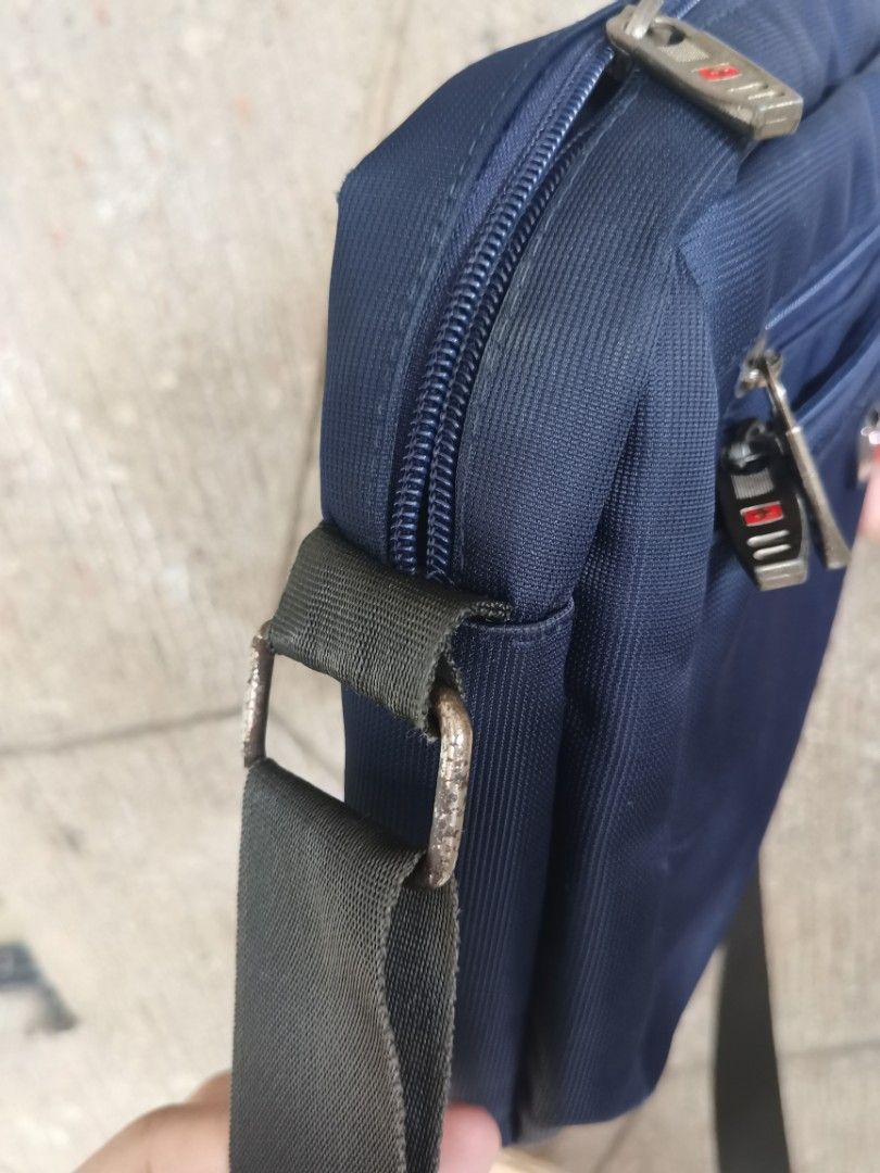 Swiss-made Messenger Bag for Men (Category: Sling Bags) located in Quezon City. Submitted by ps.thriftopia (Listing ID 1361110397, Image 3). Description: Made in Switzerland, used for several years pero maganda at matibay pa kasi swiss-made. Reliable go-to bag. Very durable material made with high quality stitching. Issues: medyo kupas yung ibang hardware as shown in the photos RFS: Decluttering, di na nagagamit.
