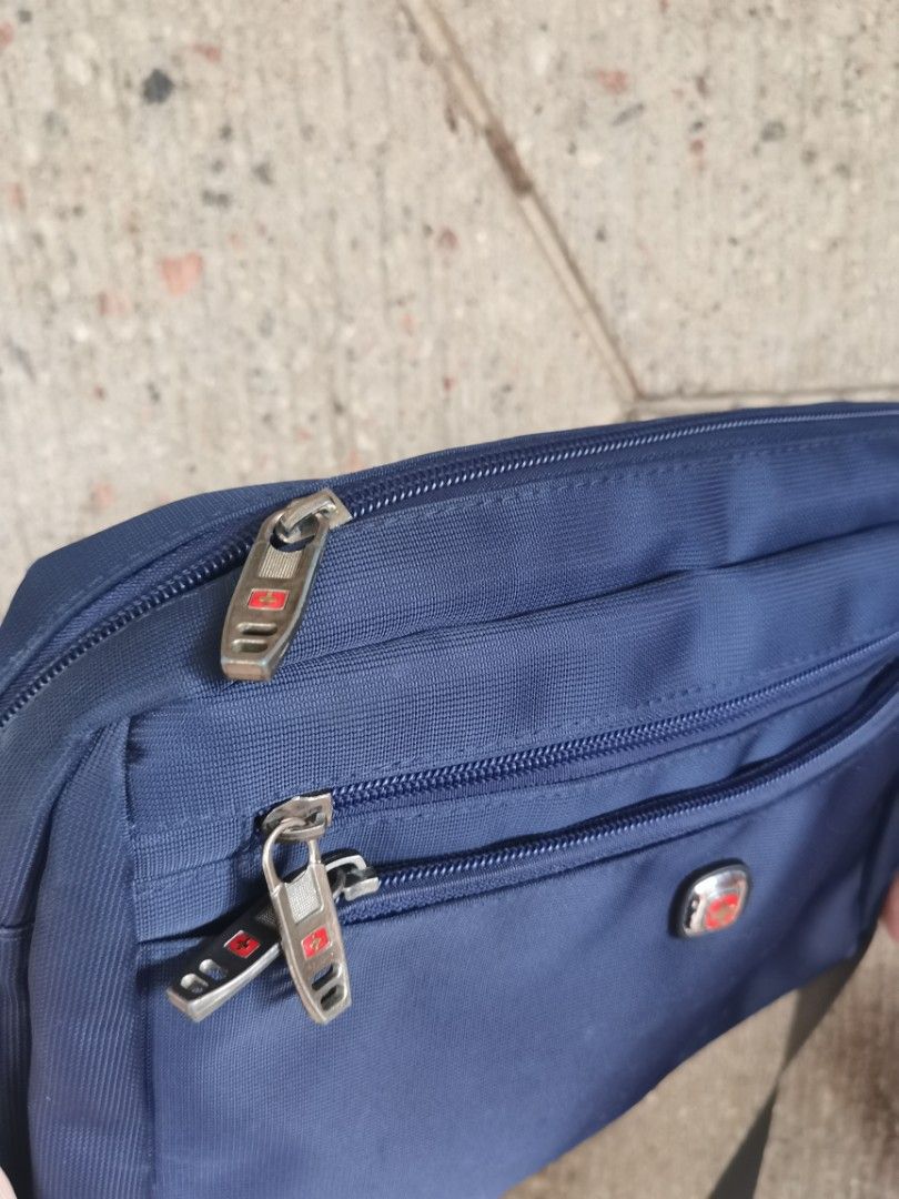 Swiss-made Messenger Bag for Men (Category: Sling Bags) located in Quezon City. Submitted by ps.thriftopia (Listing ID 1361110397, Image 2). Description: Made in Switzerland, used for several years pero maganda at matibay pa kasi swiss-made. Reliable go-to bag. Very durable material made with high quality stitching. Issues: medyo kupas yung ibang hardware as shown in the photos RFS: Decluttering, di na nagagamit.