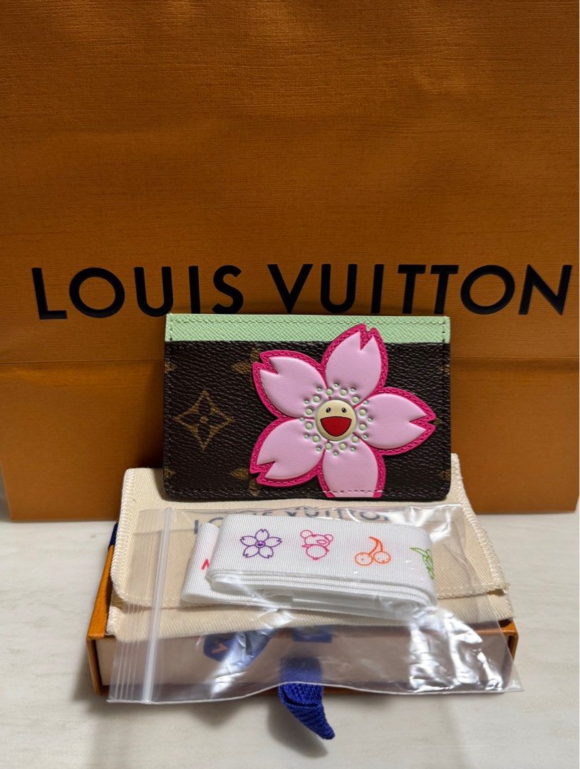 Louis Vuitton x T.Murakami (Cherry Blossom) (Category: Bags & Wallets) located in Singapore. Submitted by hypeup_flan (Listing ID 1361231449, Image 1). Description: RARE FIND – Louis Vuitton x Murakami Card Holder (Cherry Blossom). Sold out everywhere, this highly sought-after Louis Vuitton x Takashi Murakami card holder is a must-have for collectors and LV enthusiasts. Featuring Murakami’s iconic cherry blossom on premium coated canvas, this pie