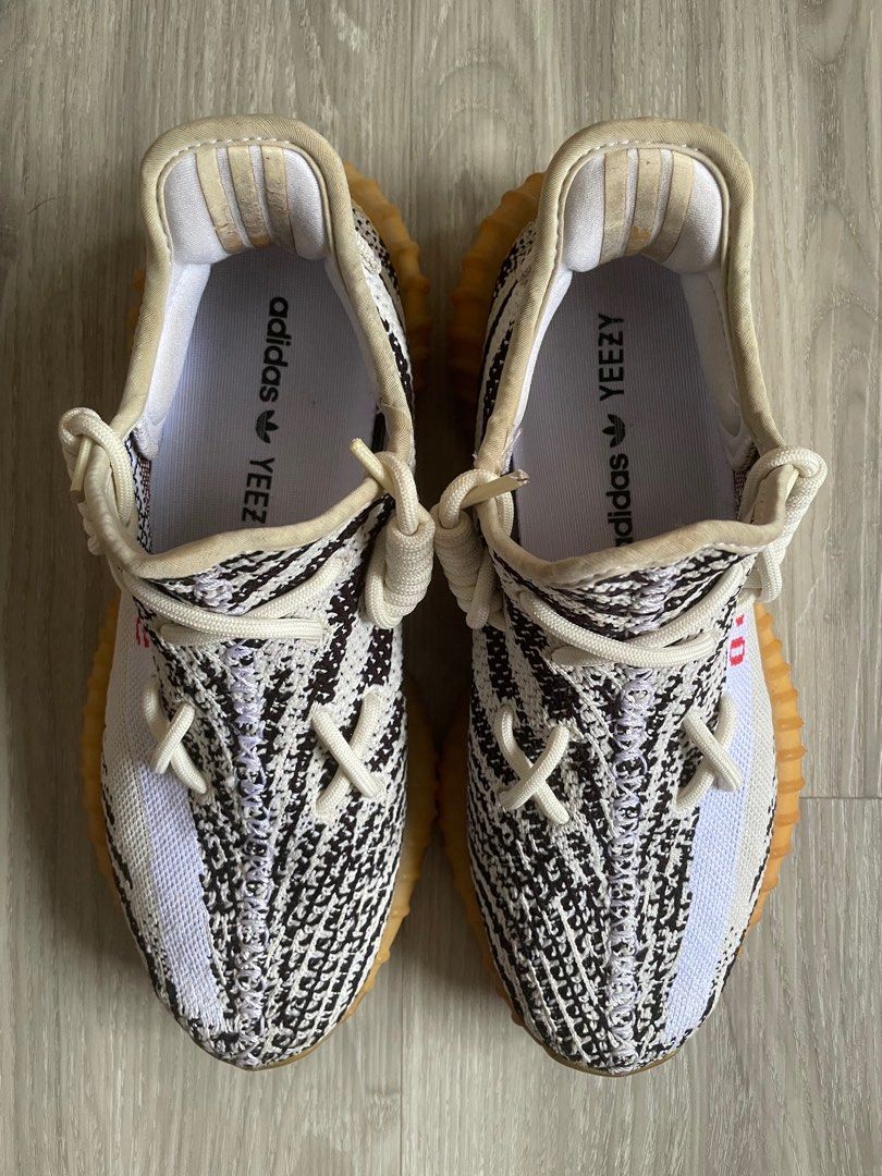 (US7.5/UK7) Yeezy Boost 350 V2 Zebra (Category: Sneakers) located in Singapore. Submitted by clearingitems_ (Listing ID 1361216150, Image 2). Description: Selling as I’m no longer wearing it anymore. Had it for many years and the boost is very yellow as shown in pictures Overall condition of sneaker is as shown in pictures Text on the receipt has also almost faded due to time.