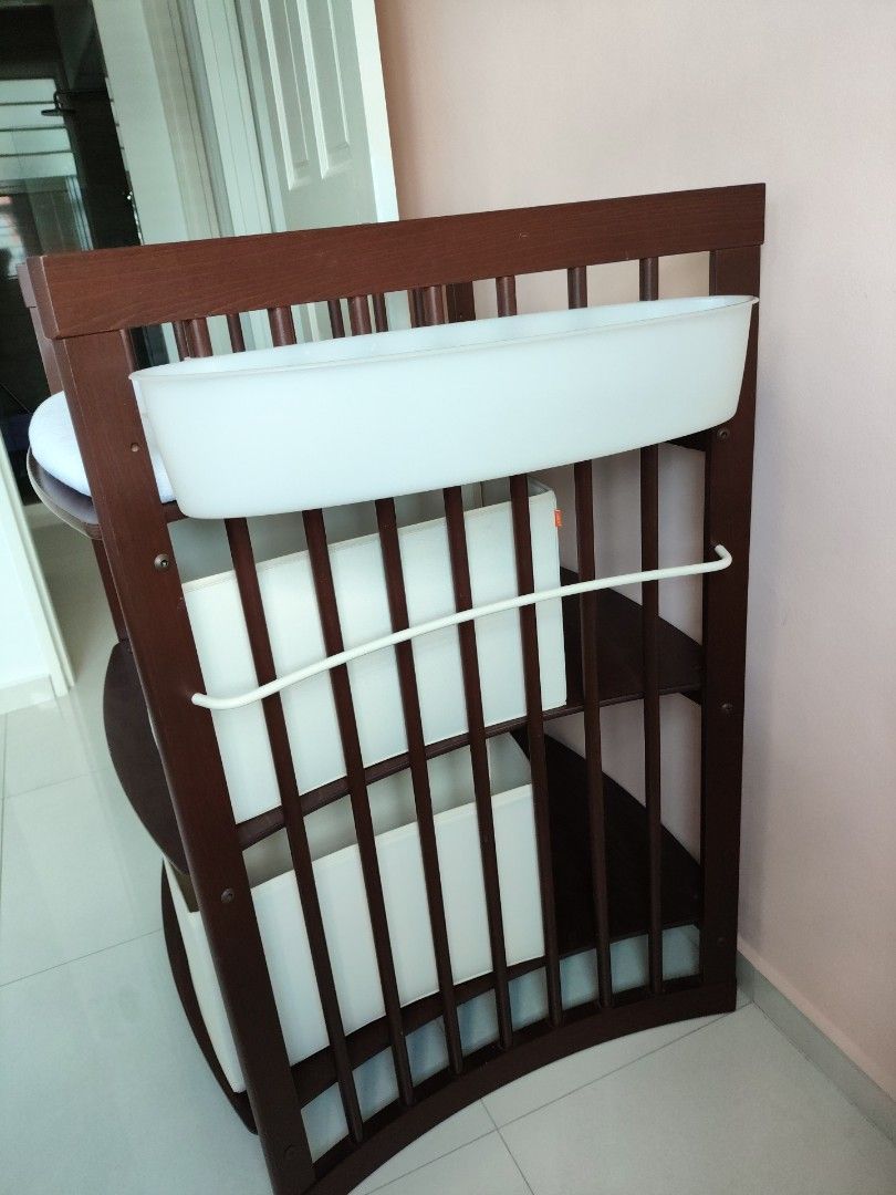 Stokke Changing Table (Category: Changing Tables & Stations) located in Singapore. Submitted by bestsecondhanddeals (Listing ID 1356285418, Image 3). Description: Walnut colour. Dimensions H107xW66xL67cm ***Two (2) fabric foldable boxes, one (1) changing mat with covers have been sold separately*** Remaining are: Two (2) plastic attachable white holders. Stokke Care is a changing table that makes nappy changes enjoyable and intimate. The changing
