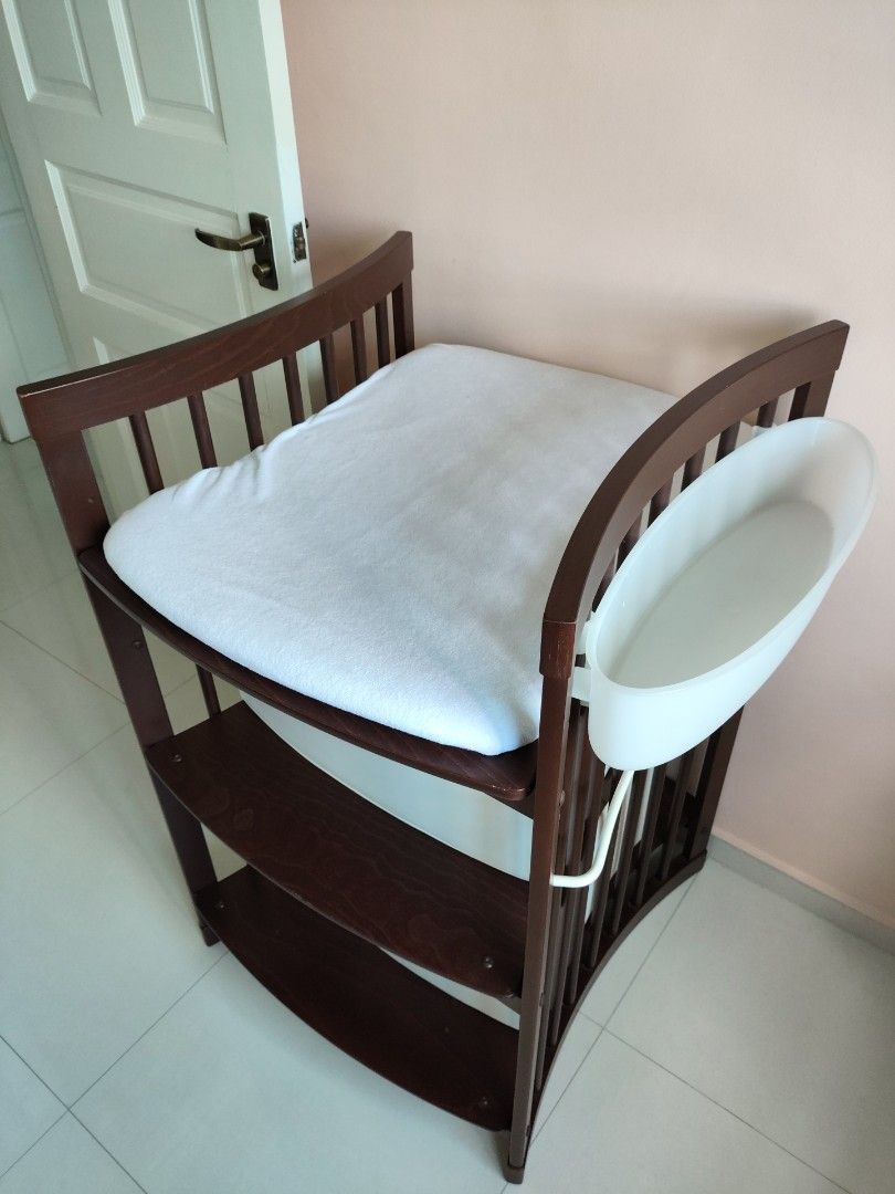 Stokke Changing Table (Category: Changing Tables & Stations) located in Singapore. Submitted by bestsecondhanddeals (Listing ID 1356285418, Image 1). Description: Walnut colour. Dimensions H107xW66xL67cm ***Two (2) fabric foldable boxes, one (1) changing mat with covers have been sold separately*** Remaining are: Two (2) plastic attachable white holders. Stokke Care is a changing table that makes nappy changes enjoyable and intimate. The changing