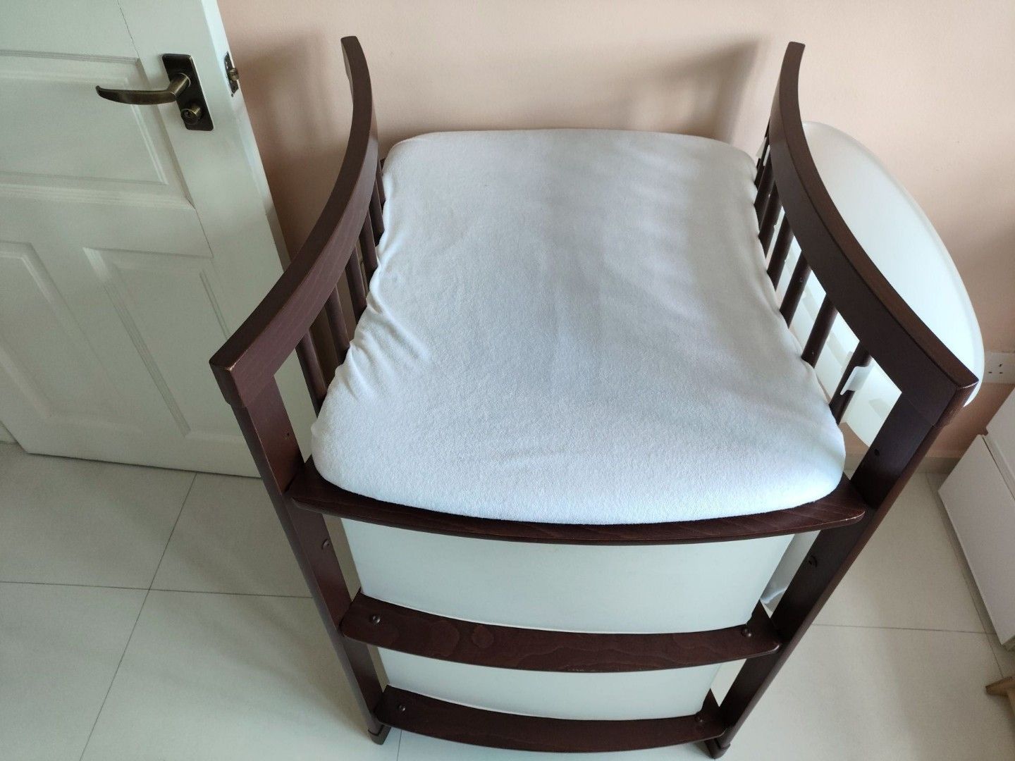Stokke Changing Table (Category: Changing Tables & Stations) located in Singapore. Submitted by bestsecondhanddeals (Listing ID 1356285418, Image 2). Description: Walnut colour. Dimensions H107xW66xL67cm ***Two (2) fabric foldable boxes, one (1) changing mat with covers have been sold separately*** Remaining are: Two (2) plastic attachable white holders. Stokke Care is a changing table that makes nappy changes enjoyable and intimate. The changing