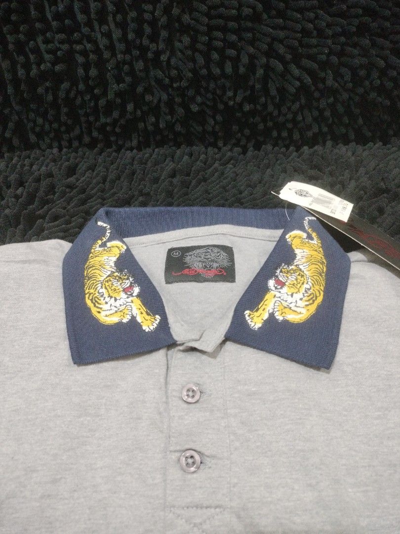 ED HARDY TIGER COLLAR POLO SHIRT (Category: Shirts) located in Mandaluyong City. Submitted by letgoph (Listing ID 1356568235, Image 3). Description: PLEASE READ WITH UNDERSTANDING. BRAND: ED HARDY Style: TIGER POLO SHIRT DEETS: Unisex Size: M on tag Dimension: 19 inches width 26 inches length 7 inches sleeves Color: Gray with embroidered tiger on dark blue collar Fabric: Cotton BNWT FLAW/S: None INCLUSION: Shirt only REASON FOR LETTING IT GO: Dec