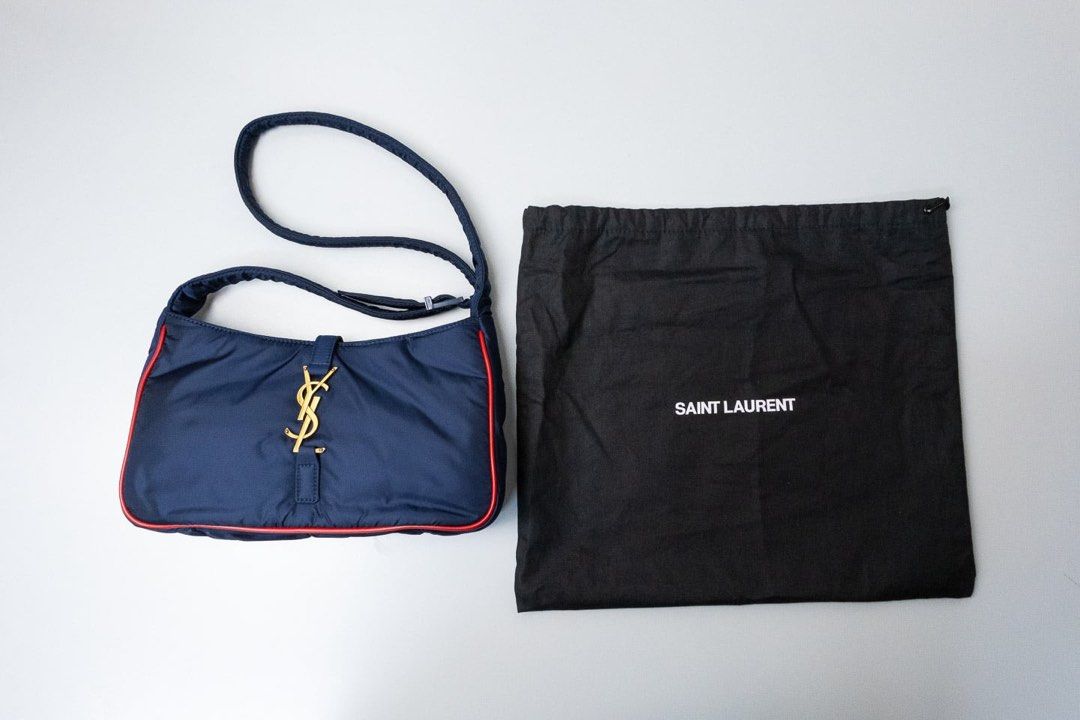 (YSL) YVES SAINT LAURENT (Category: Luxury Bags & Wallets) located in Manila. Submitted by angelokon56028 (Listing ID 1356558521, Image 2). Description: YVES SAINT LAURENT SHOULDER BAG Navy Blue Nylon & Red leather trim with gold hardware 9.5 x 2.15 x 6 cm With dustbag, card, booklet 90k (SRP 179,500) Onhand 2x Moneyback guaranteed if proven fake Location: Mandaluyong City .