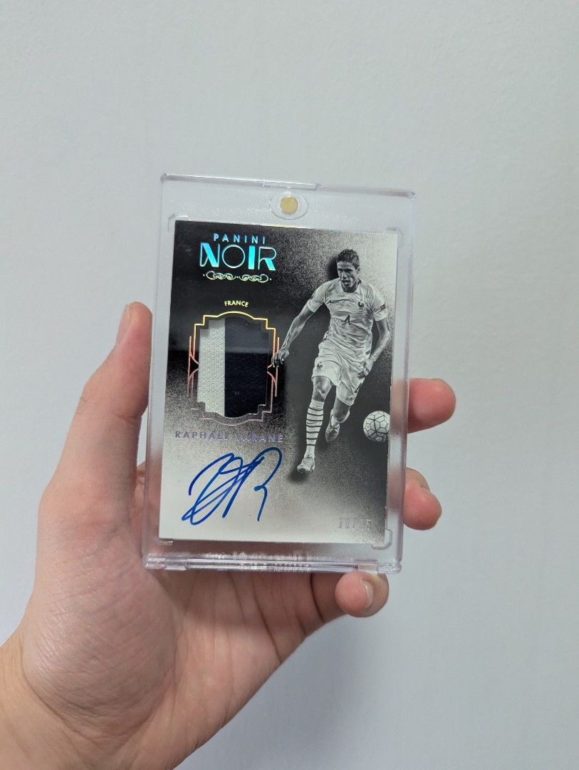 2016-17 Panini Noir Soccer RAPHAEL VARANE Oncard Patch Auto #/25 (France, Manchester United, Real Madrid) (Category: Raw Cards) located in Singapore. Submitted by shinji.collector (Listing ID 1356682841, Image 1). Description: 2016-17 Panini Noir Soccer RAPHAEL VARANE Oncard Patch Auto #/25 FREE TRACKED MAIL.