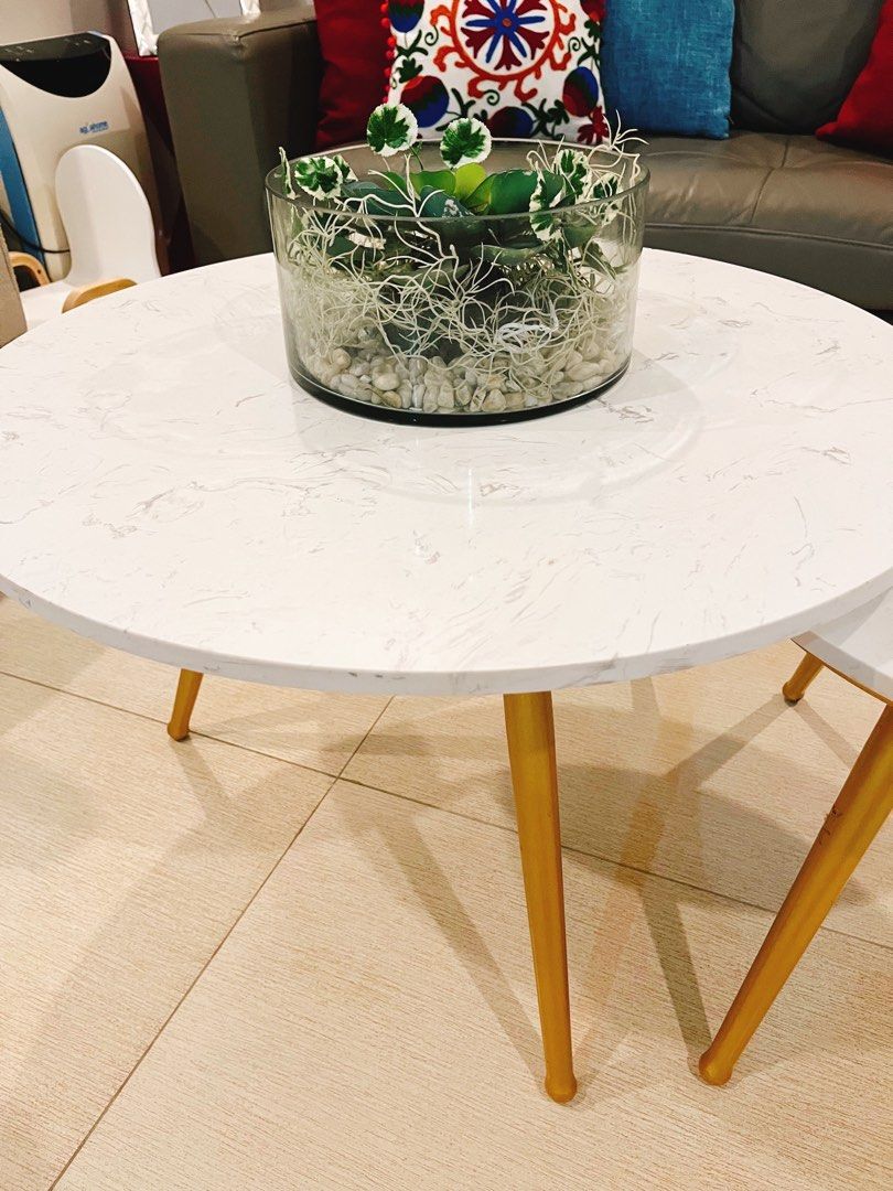 Coffee Tables (Marble Stone Top) (Category: Tables & Sets) located in Manila. Submitted by prelovedbycristinemargaux (Listing ID 1356983776, Image 3). Description: 2 Pieces of Round Nesting Center Tables Materials: - White Carrara Marble Stone Top - Tripod Metal Legs painted in gold - Very heavy and sturdy Defects: - Chipped paint on the foot of the metal legs as seen on the photos Sizes: Bigger Table (70 cm dia. x 45 cm height) Smaller Table (48