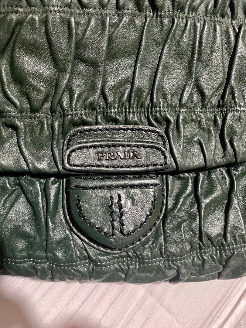 PRADA leather green shoulder bag (Category: Luxury Bags & Wallets) located in San Pablo. Submitted by prelovedbymistyblue (Listing ID 1356933209, Image 3). Description: Leather Large Prada green shoulder bag. Still nice. With some signs of use on the leather. Adjustable sling. With pocket on the back. Lampo zipper. With leather tag. Measures 13 x 8.5 x 4 inches. Selling low for 6000, down to 4000, down to 2500. Had part with peeling hence selling