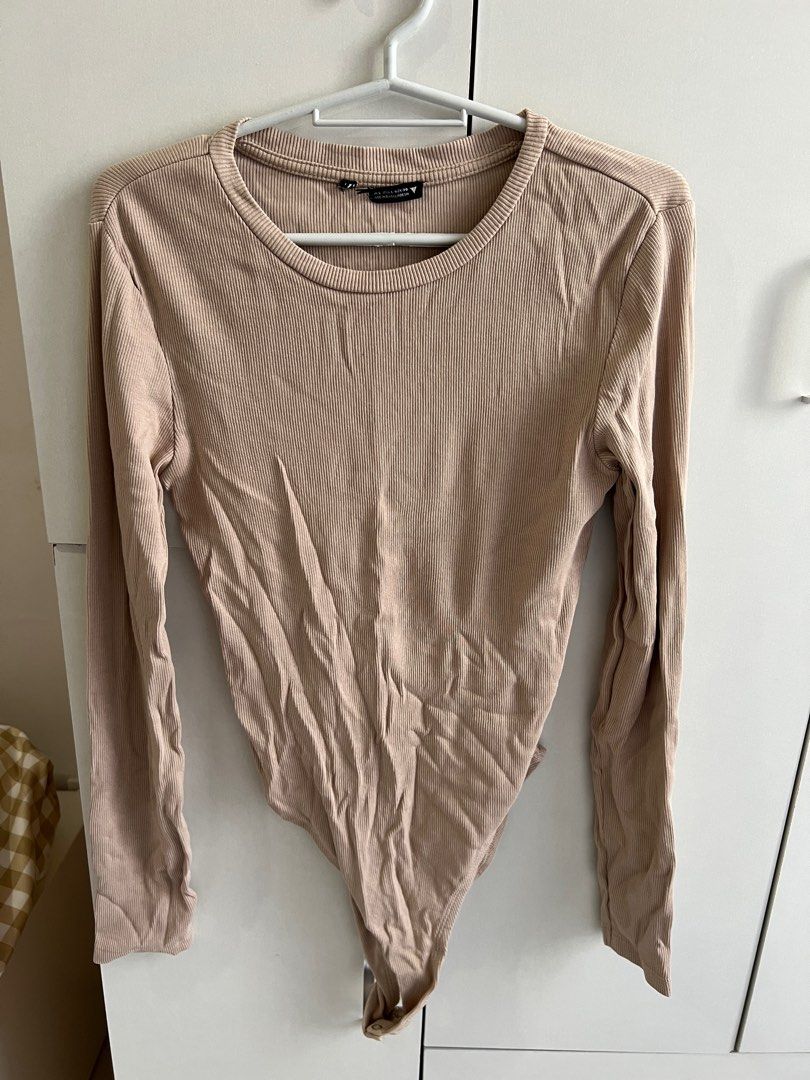 Brown longsleeves bodysuit (Category: Longsleeves) located in Bulacan. Submitted by lezzdeclutter (Listing ID 1357091527, Image 1). Description: Can fit Medium to Large Personal fave ✨💯 NO Flaws Rfs: decluttering since i’m now pregnant 📍Malolos, Bulacan.