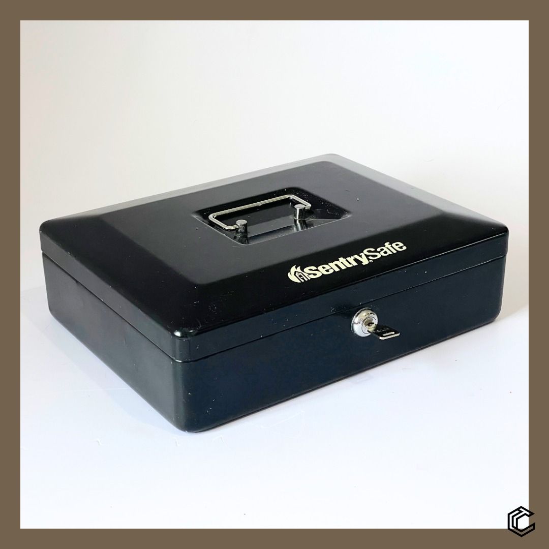 SentrySafe Locking Cash Box – Model CB-12 (Category: Safe) located in Bacoor. Submitted by box_of_randoms (Listing ID 1357121159, Image 1). Description: Specifications: • Brand: SentrySafe • Model: CB-12 • Type: Locking Cash Box • Color: Black • Material: Solid steel construction for durability • Lock Mechanism: Keyed lock (1 key included) • Capacity: 0.21 cu. ft. • Peril Type: Security Dimensions: • Exterior: 3.7 in H × 11.8 in W × 9.3 in D • In