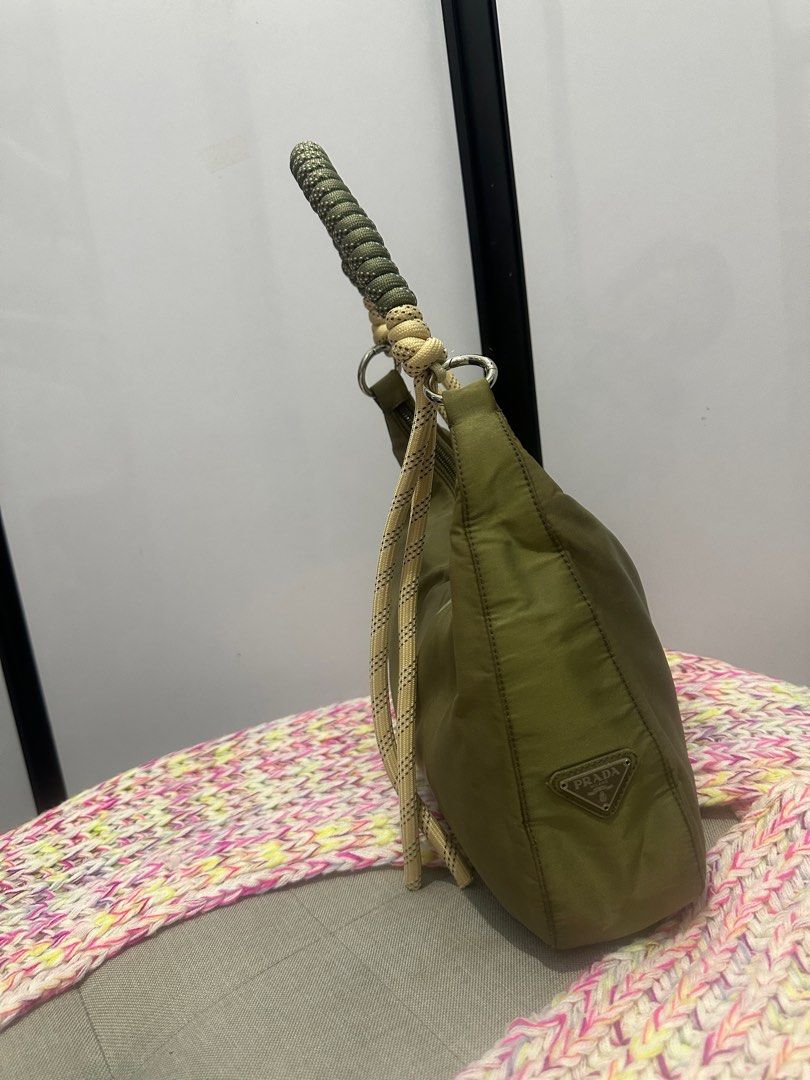 Authentic Prada kilikili bag (Category: Luxury Bags & Wallets) located in Paranaque City. Submitted by jomaaaalones (Listing ID 1357382211, Image 1). Description: selling this authentic prada kilikili bag changed the strap already from a polycarbonate plastic hardware strap to this cutesy rope style generic kilikili strap i bought in Michaels(us). You can change it to another strap as well of your preferences Bag is greenish with discoloarations 