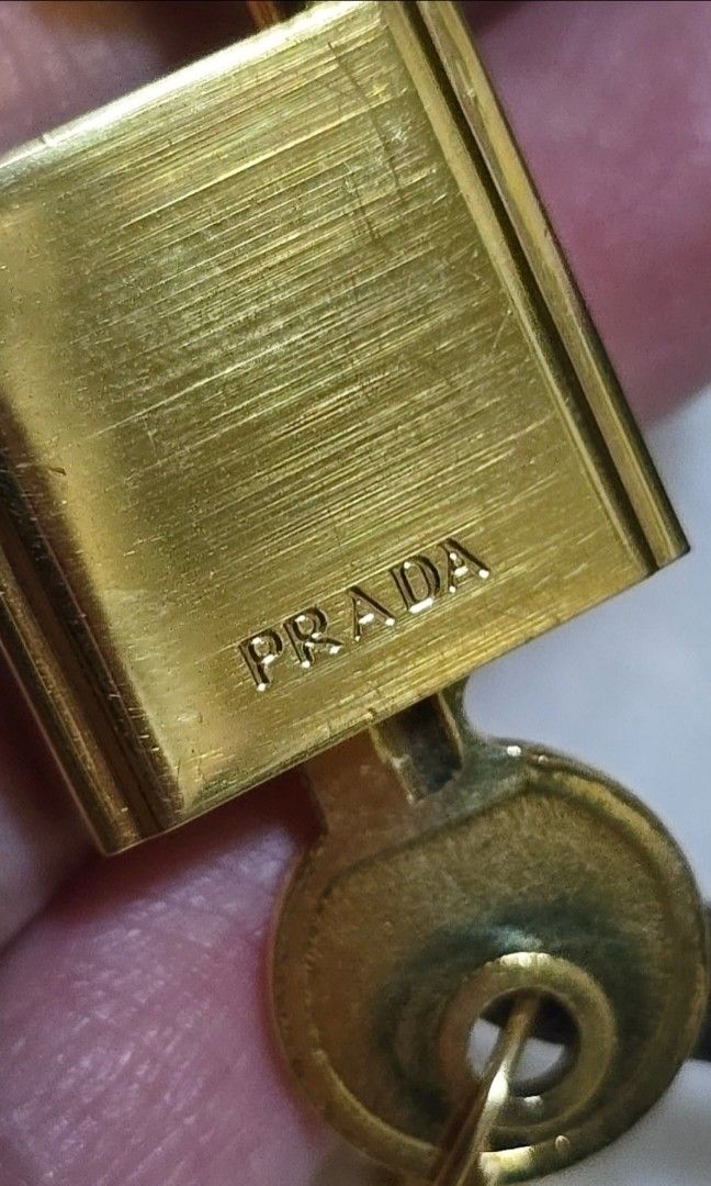 Authentic prada lock padlock from a leather handbag (Category: Luxury Accessories) located in San Juan City. Submitted by akioza (Listing ID 1357377241, Image 3). Description: (reduced to low simply bec. Im in mnl at the moment... just visiting occasionally to care for elderly relatives) lovely. gold. unisex. with its black leather tag 2 keys. all working condition is great, it's been stored lang with other trinkets and knick knacks in my old roo