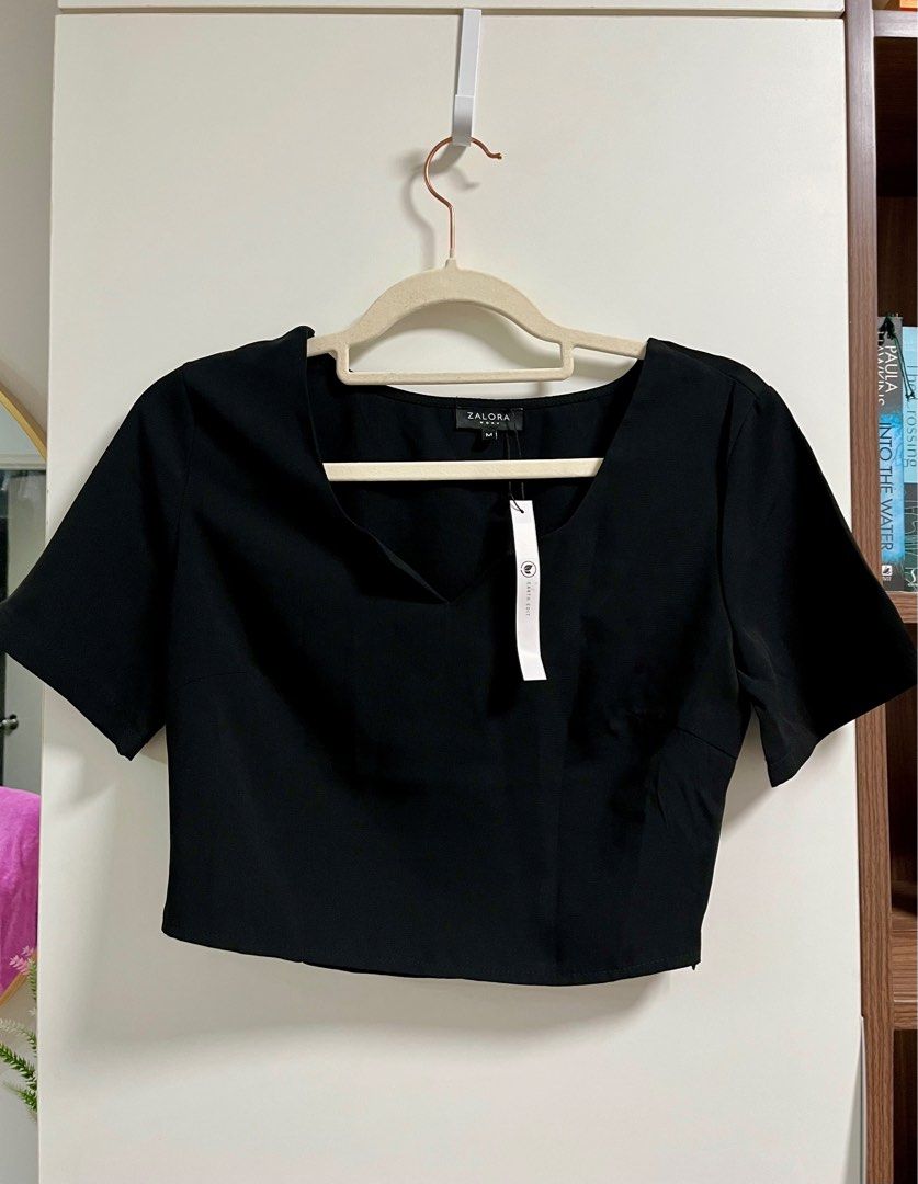 Black crop blouse (Category: Blouses) located in Taguig. Submitted by decluttering_my_stuff (Listing ID 1361425584, Image 1). Description: Black crop blouse with side zipper -Bought directly from Zalora with tags for P850 -Medium size but fits smaller frame RFS: Too small for me.