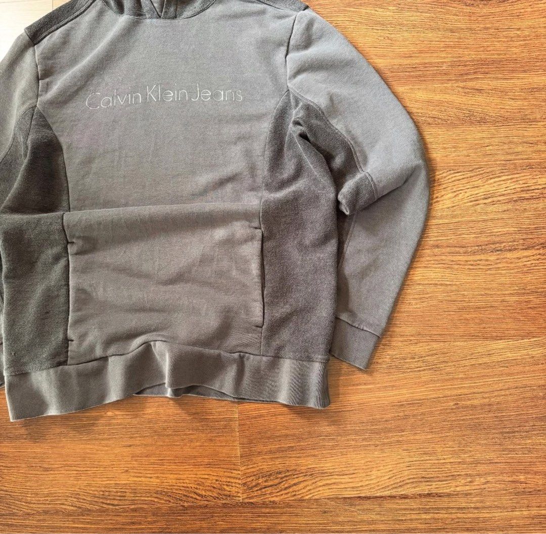 Calvin Klein hoodie (Category: Coats, Jackets and Outerwear) located in Binan City. Submitted by luckythriffs (Listing ID 1361415051, Image 3). Description: Calvin Klein Hoodie Condition: 9/10 Issues: stain ~Dimes~ M on tag Length: 27” Width: 20”.