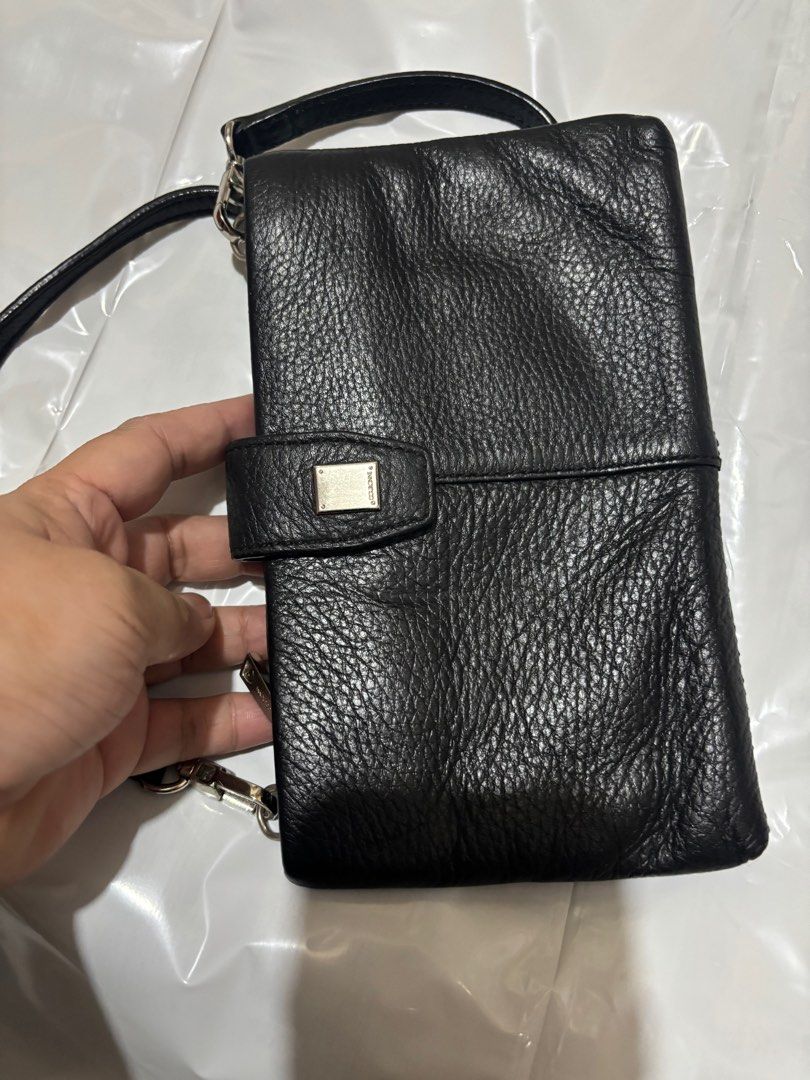 Courrone wallet sling (Category: Luxury Bags & Wallets) located in Makati City. Submitted by issa124 (Listing ID 1361478842, Image 3). Description: Courrone wallet sling. Pure leather. Preloved but still very nice. With short sling. Size :8x4.7 inches. .