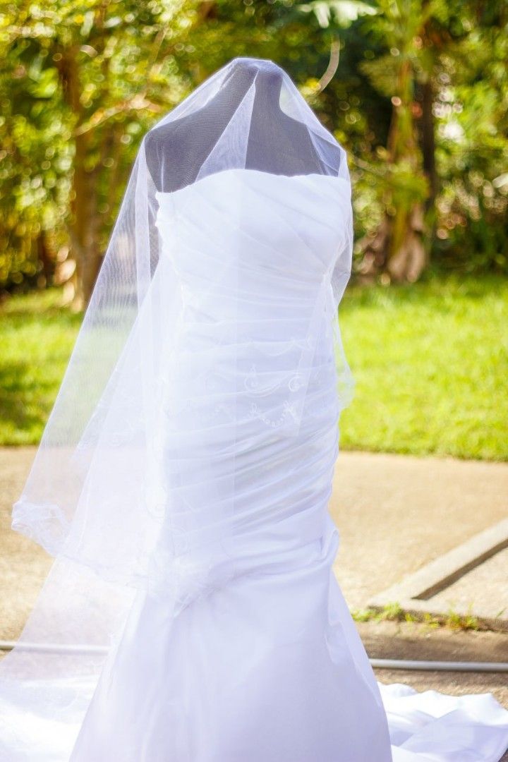 Serpentine-cut wedding gown (Category: Evening dresses & gowns) located in Cavite. Submitted by mdsmak (Listing ID 1362929201, Image 2). Description: Serpentine wedding gown With adjustable criss cross tie at the back 3-meters long trail Includes all accessories: veil, cord, coins, ring cushion, garter Issue: yellow stains in some parts due to the clip (washable).