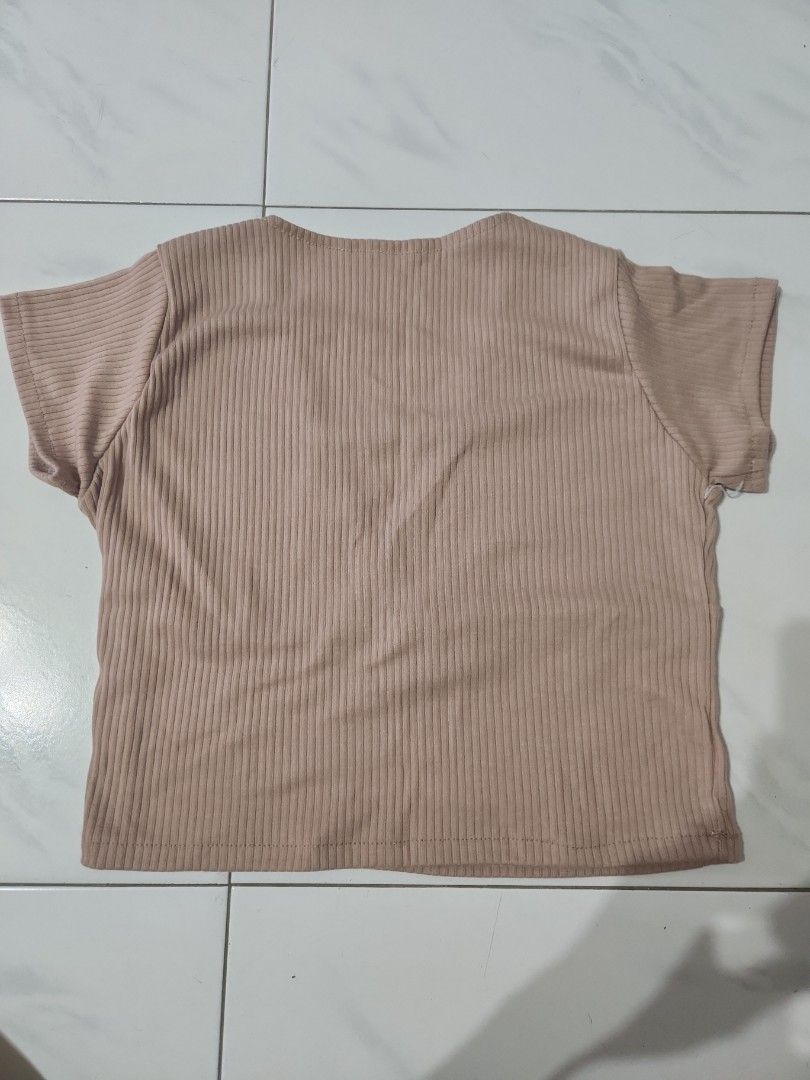Light Brown top (Category: Blouses) located in Singapore. Submitted by shoprb (Listing ID 1363101708, Image 2). Description: fits size M brand new, never worn before. looks like a wrap top ribbed material, very soft and comfy for sg weather mailing available at additional $3.