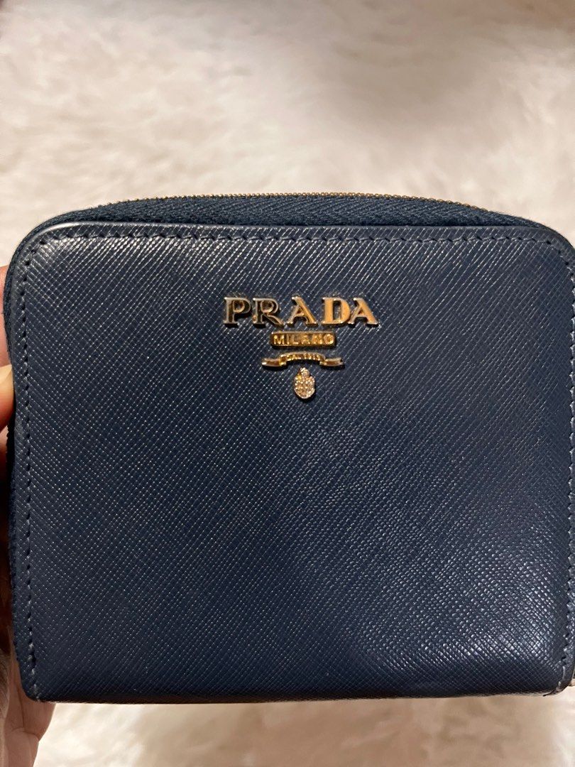 MUST GO! AUTH PRADA BIFOLD WALLET (Category: Luxury Bags & Wallets) located in Pasay City. Submitted by lovefashionstuff (Listing ID 1338900389, Image 3). Description: color: navy blue guaranteed 💯 authentic bi-fold saffiano leather with signs of use but well used inclusions: wallet only 4x4 inches no to bogus buyers..