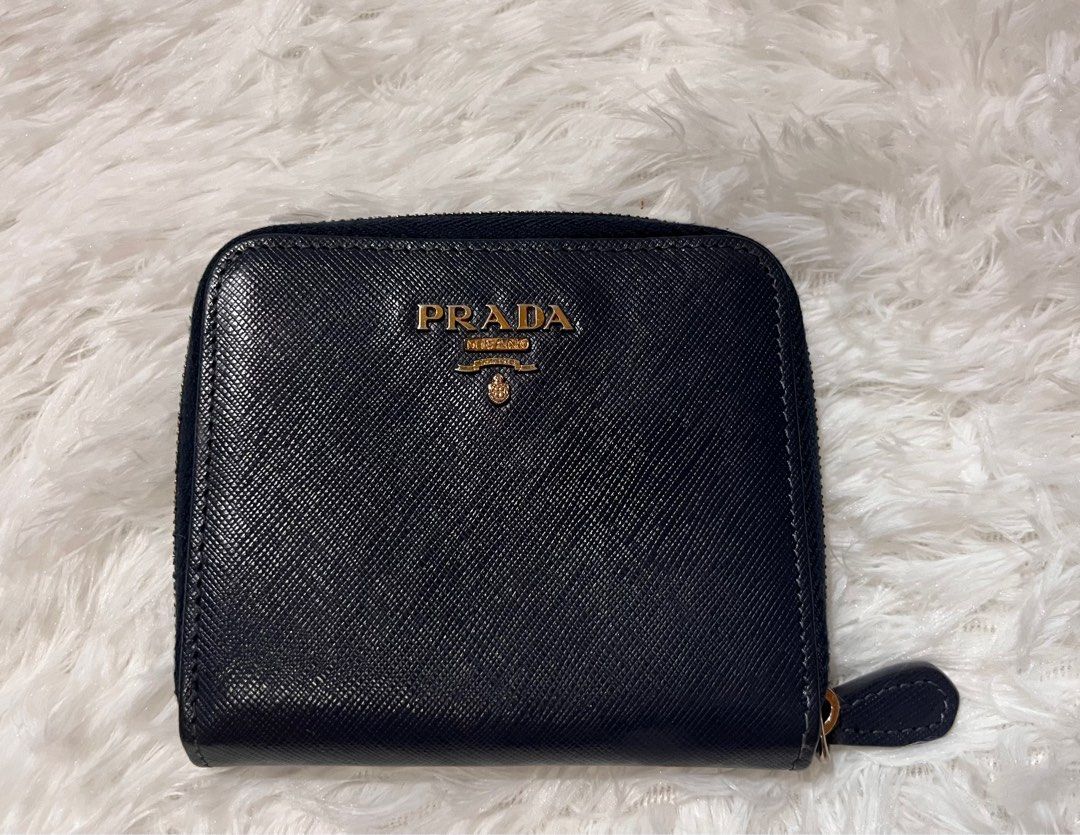 MUST GO! AUTH PRADA BIFOLD WALLET (Category: Luxury Bags & Wallets) located in Pasay City. Submitted by lovefashionstuff (Listing ID 1338900389, Image 1). Description: color: navy blue guaranteed 💯 authentic bi-fold saffiano leather with signs of use but well used inclusions: wallet only 4x4 inches no to bogus buyers..
