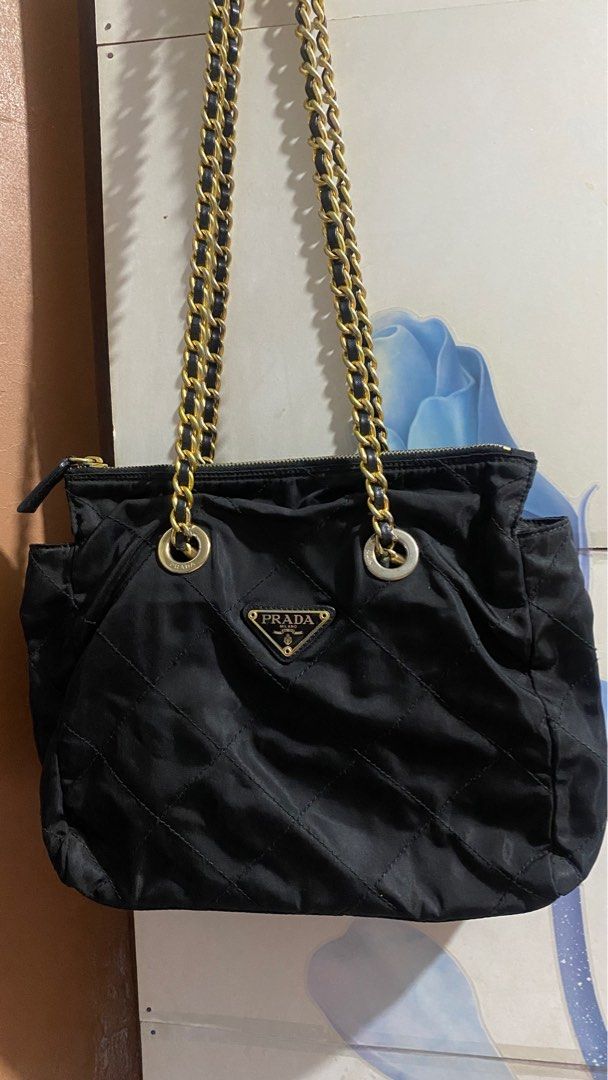 Prada Tessuto Chain bag (Category: Luxury Bags & Wallets) located in Quezon City. Submitted by maismaria (Listing ID 1363478285, Image 2). Description: Authentic No tears, No rips Gold Chain strap shows sign of fading Rivets are faded Still presentable and usable RFS No longer being used .