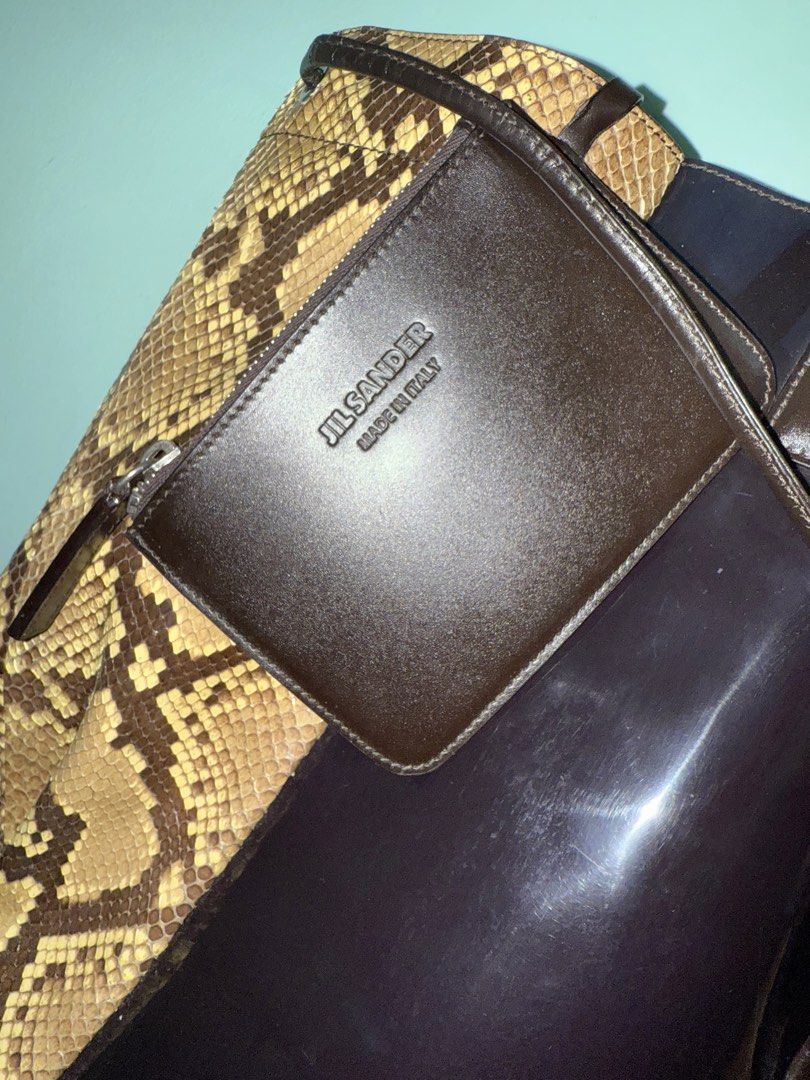 Auth Jil Sander Python/PVC Tote Bag (Category: Luxury Bags & Wallets) located in Cavite. Submitted by okaypreloved (Listing ID 1363700557, Image 2). Description: 2012 Runway Piece by Raf Simons for Jil Sander FLAWS Signs of usage Expired strap adhesive of pouch (ex pic 6) Expired Edge Seal of leather handles (ex pic 7) *PVC appears purplish *MEET-UP ONLY ALL SALES ARE FINAL AND NONRETURNABLE.