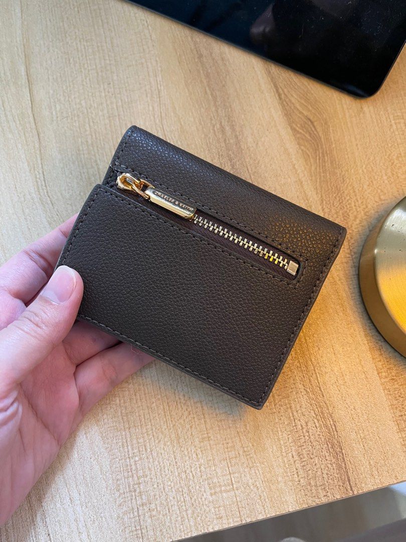 ORIGINAL C&K compact wallet (Category: Wallets & Card holders) located in Batangas. Submitted by hellocedi (Listing ID 1363543241, Image 3). Description: RFS: Not my go to wallet and has been with me for a year. Mainly used it for travel to store other currencies -Comes with its original box and dust bag -Not sure if you can wipe off the hardware dust/stain. -pebbled synthetic leather -very compact -6 card slots -zippered coin compartment -pwede 