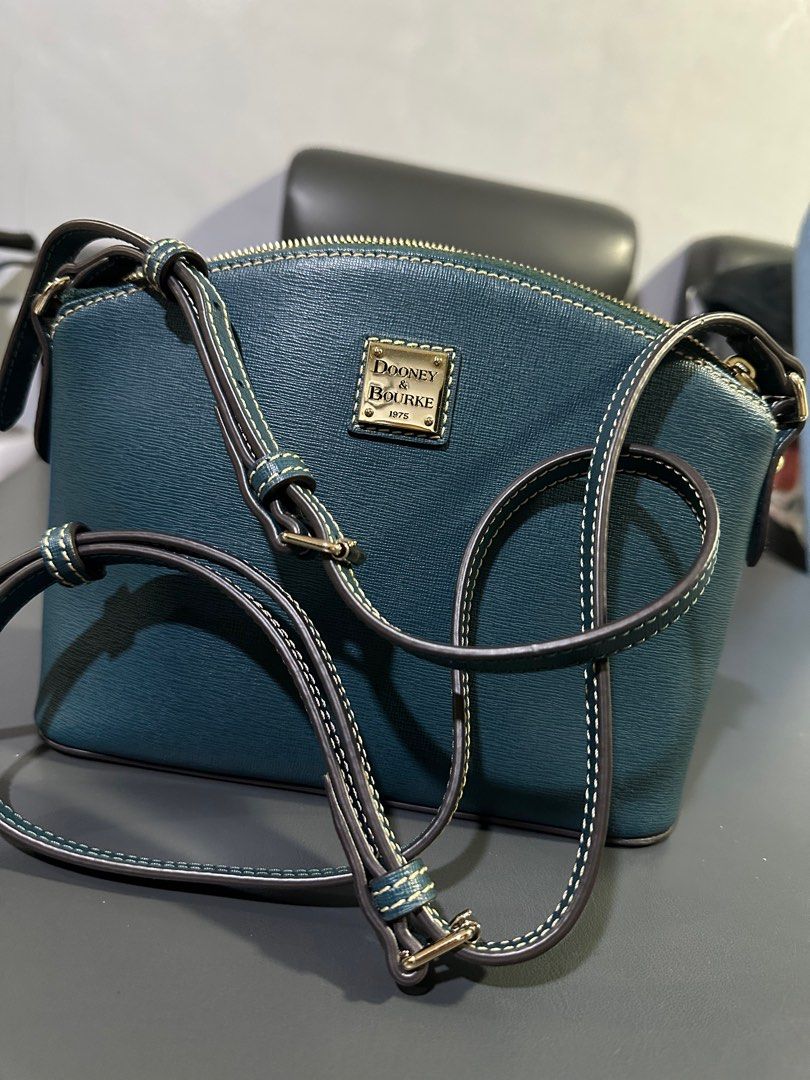Dooney and Bourke Bag (Category: Luxury Bags & Wallets) located in Cainta. Submitted by annebc (Listing ID 1363699796, Image 3). Description: Color Teal Zipper closure H 7” x W 4.25” x L 8.75” 14 oz Designed in Norwalk, CT by Peter Dooney. Lined. Complete with dust bag and care card.