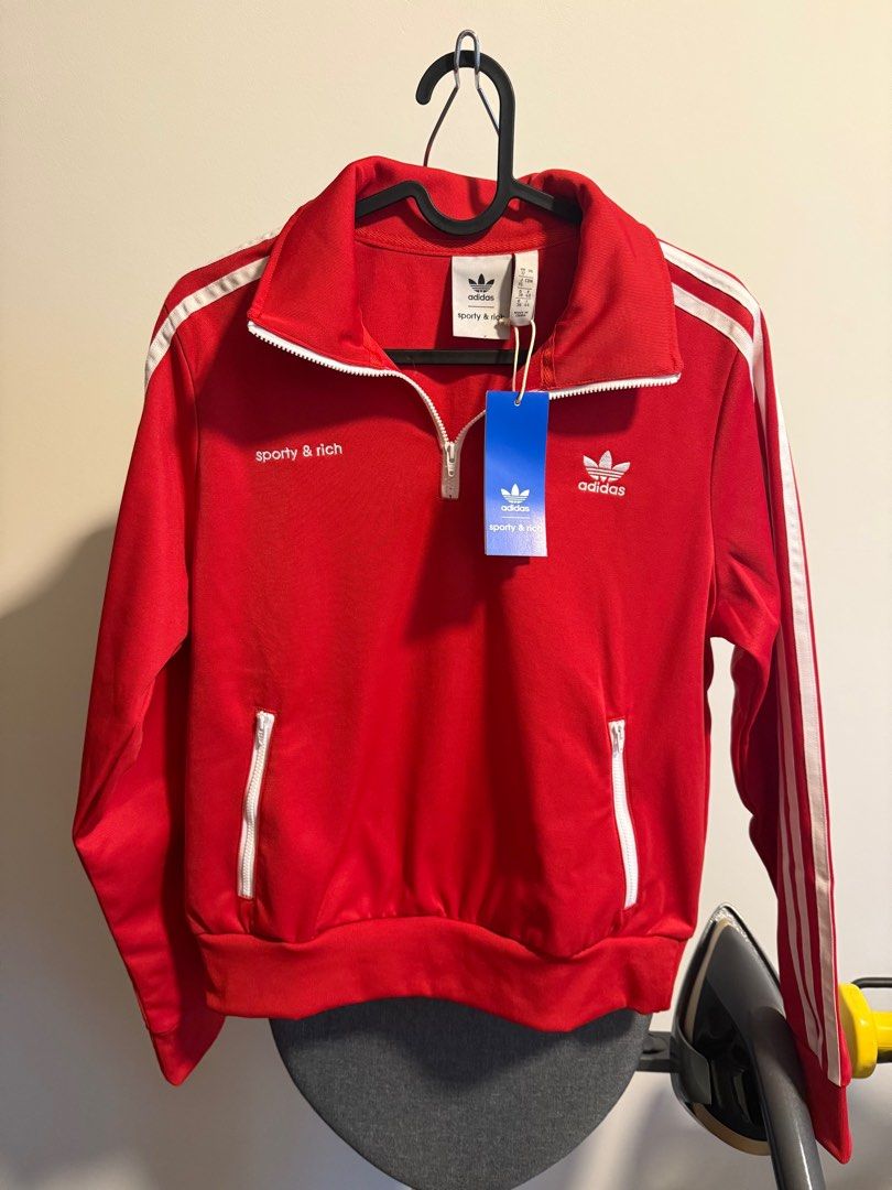 BNWT Sporty & Rich x Adidas half zip Jacket (Category: Activewear) located in Singapore. Submitted by goldenslumbers (Listing ID 1363794147, Image 1). Description: Brand new with tags and out of stock! Please check tags for sizing of different countries, and measurements below: 18” PTP 23” Length Free normal mail :).