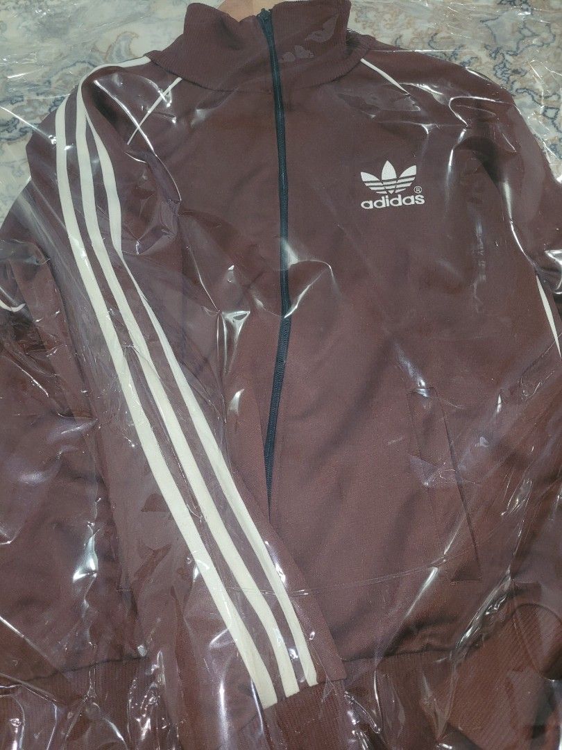 Adidas Jacket (Category: Activewear) located in Singapore. Submitted by ADIDASMUSEUM (Listing ID 1363935621, Image 1). Description: a brown with cream stripes Adidas vintage tracktop jacket still in pristine condition. a must have for vintage collectors..