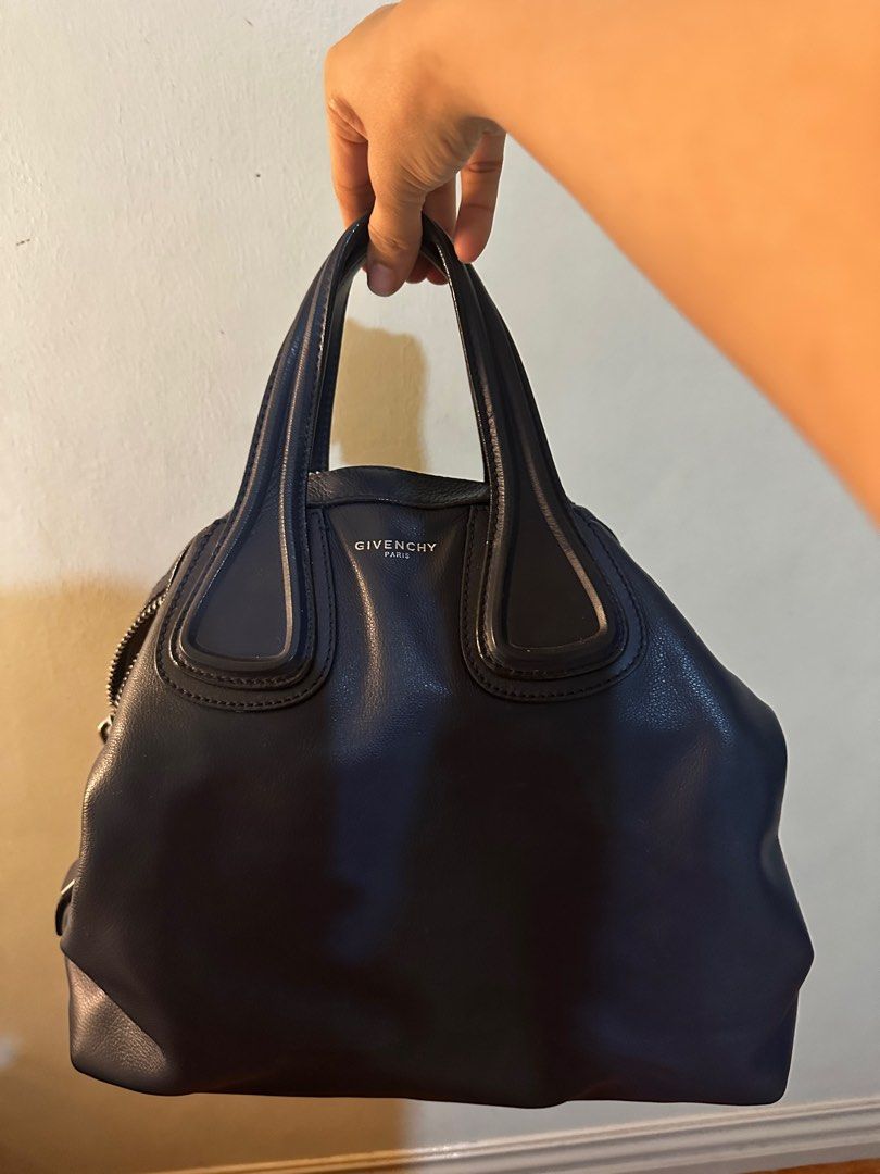 Givenchy Nightingale (Category: Luxury Bags & Wallets) located in San Fernando. Submitted by miss_peng (Listing ID 1364027768, Image 1). Description: GIVENCHY NIGHTINGALE LARGE LEATHER SATCHEL YEAR: 2015 HARDWARE: Silver Tone CLOSURE: Top zip INTERIOR: Fabric lining with zip pocket and slip pockets INCLUDES: Bag & dust bag Condition: Gently used with minor creasing Interior has a few ball pen marks and stains .