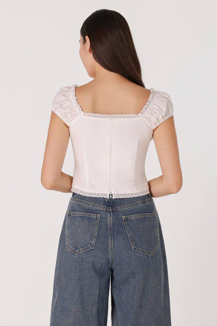 Lovet padded corset top (Category: Blouses) located in Singapore. Submitted by wanderllost (Listing ID 1363958032, Image 3). Description: Lovet Ciera padded corset in white in excellent condition - Worn once, selling as too many similar pieces! - Super cute, classic wardrobe staple. Elegant and dainty piece, easy to pair with a variety of skirts, shorts and pants - Comes with bra padding - Size S, best fit UK 8 +$2.80 Singpost tracked mailing UP 