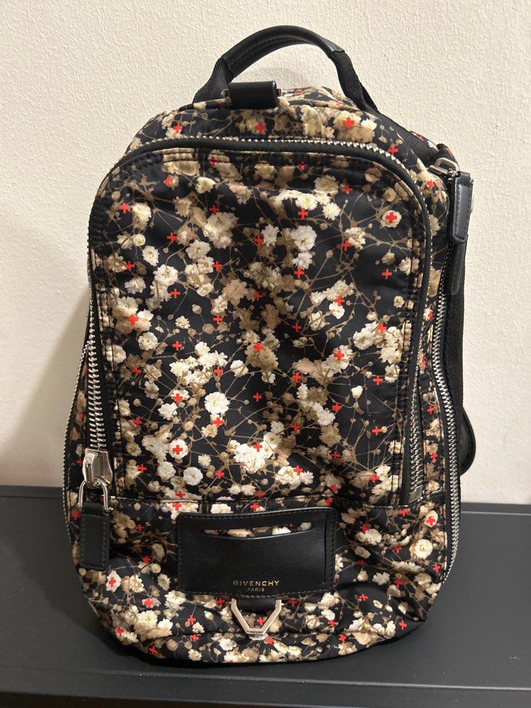 Authentic Givenchy Backpack (Category: Bags & Wallets) located in Singapore. Submitted by diva_mama (Listing ID 1240052786, Image 1). Description: Preloved Authentic Givenchy backpack Iconic flower design Estimated measurements: 25cm x 30cm Hardly used Selling much cheaper than retail price to clear space Low ballers stay away please. Serial code tag in good condition Comes with dust bag Sale will be final no refund return or exchange after deal.