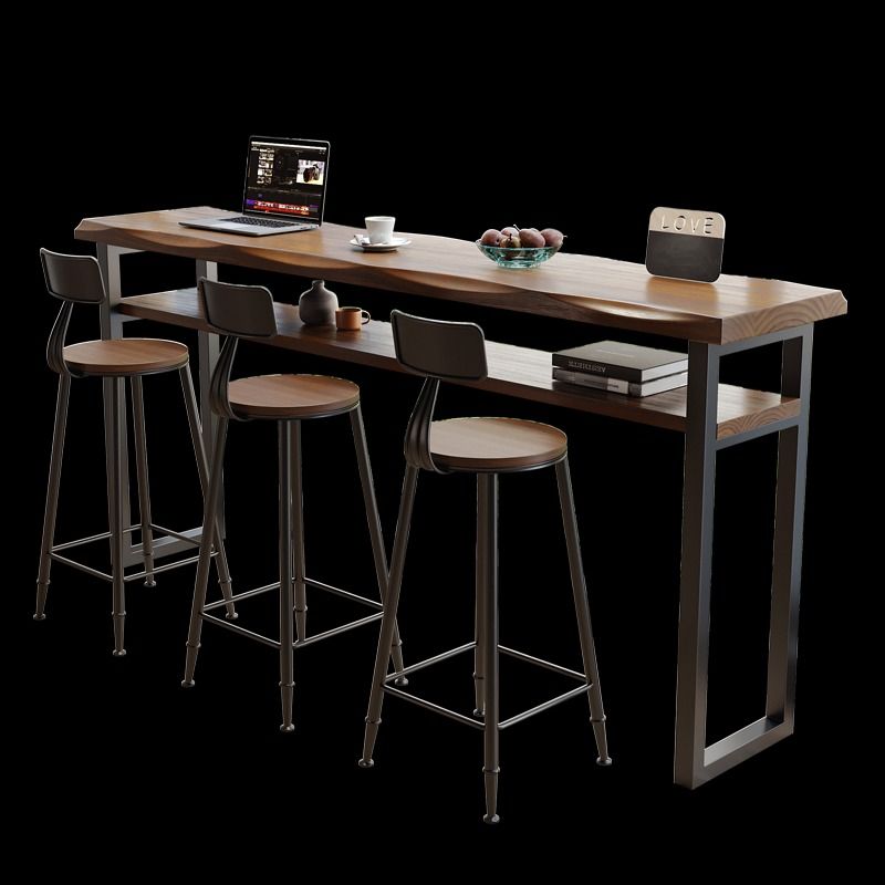 BILLY Rustic Solid Wood Bar Table (Category: Tables & Sets) located in Singapore. Submitted by homejourney.sg (Listing ID 1364098052, Image 3). Description: Redefine your bar area or outdoor lounge with our BILLY bar table. Crafted from pine wood in a beautiful matte walnut finish, its natural wavy edge adds an organic touch to your space. A convenient shelf beneath offers storage space for your laptop and books when entertaining guests. Whether 