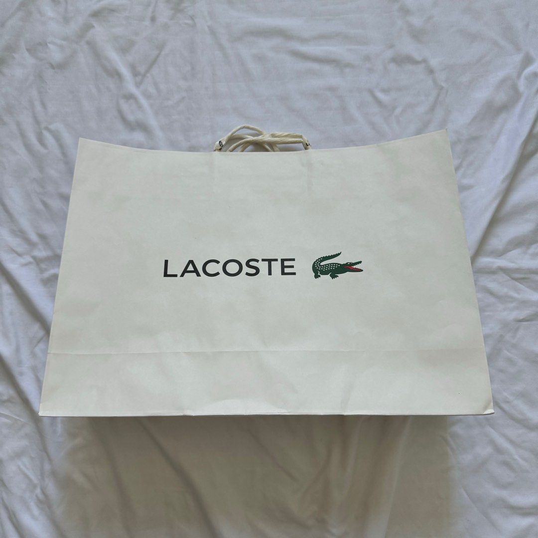 Lacoste Paper Bag (Category: Luxury Bags & Wallets) located in Paranaque City. Submitted by contactcars (Listing ID 1063013097, Image 2). Description: RFS: Decluttering by getting rid of old boxes / paper bags. From a bag bought at Lacoste Glorietta. Dimensions: 16.25W x 12H x 4.75D inches.