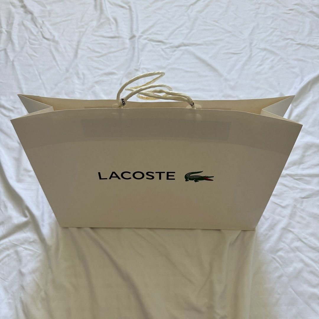 Lacoste Paper Bag (Category: Luxury Bags & Wallets) located in Paranaque City. Submitted by contactcars (Listing ID 1063013097, Image 1). Description: RFS: Decluttering by getting rid of old boxes / paper bags. From a bag bought at Lacoste Glorietta. Dimensions: 16.25W x 12H x 4.75D inches.