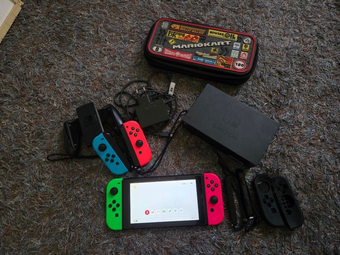 Nintendo Switch (Category: Nintendo) located in Pasig City. Submitted by seisei20 (Listing ID 1364139221, Image 3). Description: Selling my Nintendo Switch 64 GB Memory Card Includes: -- 4 controllers All working controllers incl wirelessly Blue - Stick drift Green - does not connect directly to the console, but charges, can be used bec its wireless. -- USB charger -- HDMI cord -- stand -- Case please see pics..