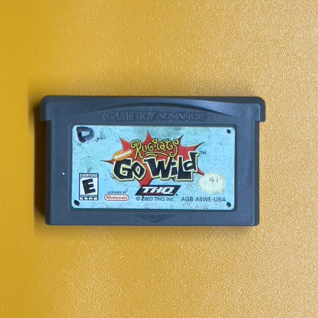 Rugrats Go Wild (Category: Nintendo) located in Cavite. Submitted by majoh_retro (Listing ID 1364088313, Image 1). Description: The image shows a cartridge for the Game Boy Advance game “Rugrats Go Wild,” released in 2003 by THQ. Key details include: Game Title: Rugrats Go Wild, a crossover between the Rugrats and The Wild Thornberrys. Platform: Game Boy Advance. Rating: E for Everyone by the ESRB. Copyright: © 2003 THQ Inc. Region Code: AGB-A5WE